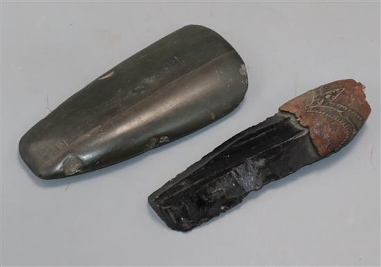 A Neolithic stone hand axe and an obsidian blade with knapped edges and the remains of a carved wood mount